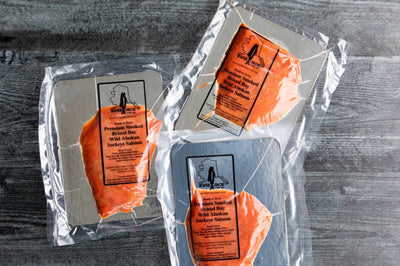 Kwee-Jack Fish Co. Wild Alaskan Nova Cold Smoked Salmon vacuum sealed and ready to eat on serving board.