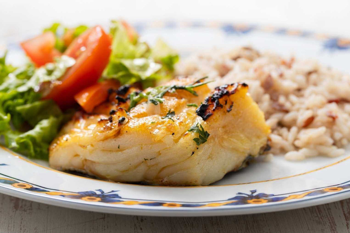 Wild Alaskan Cod grilled with whole grain rice and a side salad