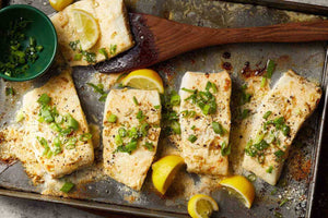 Wild Alaskan Halibut on sheet pan with green onion and lemon