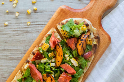 Kwee-Jack wild caught smoked salmon on flatbread with lettuce and roasted squash and corn.